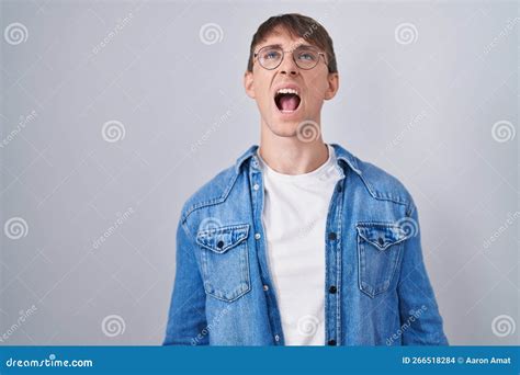 Caucasian Blond Man Standing Wearing Glasses Angry And Mad Screaming