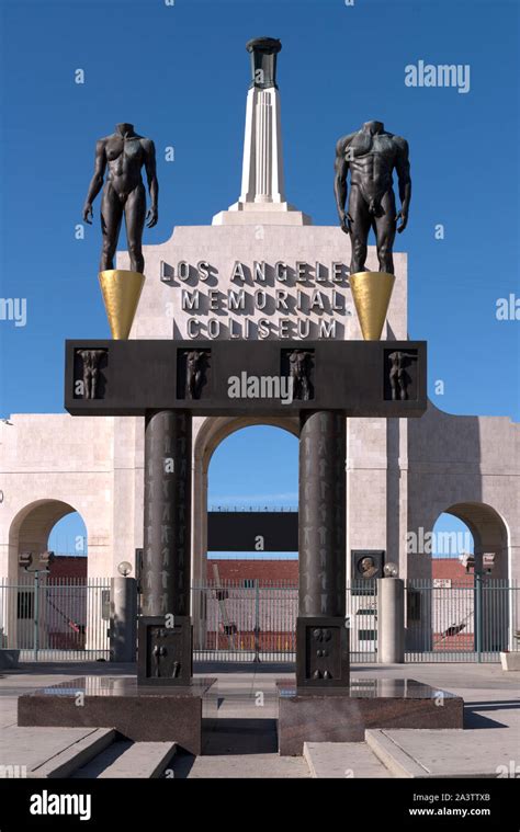 The Olympic Gateway Arch And Male And Female Statues At The Entrance To