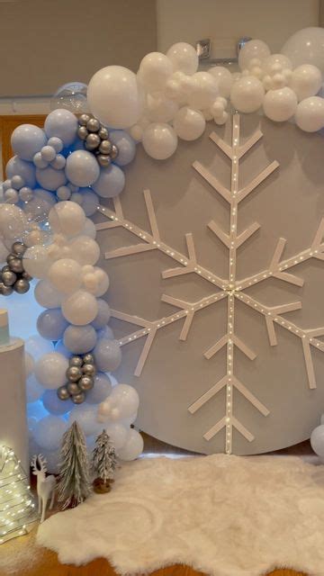 A Table Topped With Balloons And Snowflakes