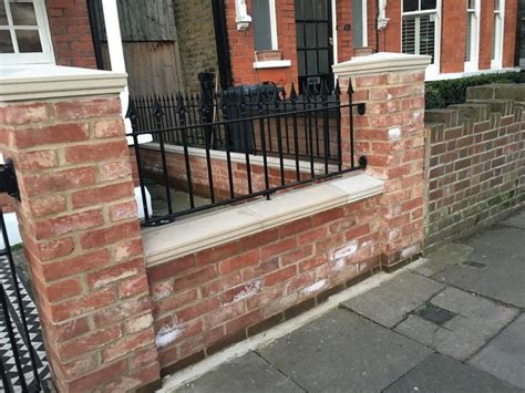 Pretty West London Red Brick Front Wall With Stone Effect Caps And Iron