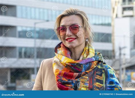 A Beautiful Blonde Years Old In A Coat And With A Scarf On The