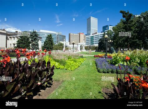 Lush flower gardens, Voorhees Memorial Seal Pond, modern city skyline ...