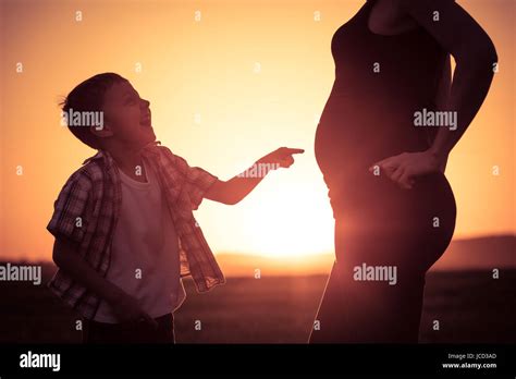 Mother And Son Walking On The Field At The Sunset Time People Having