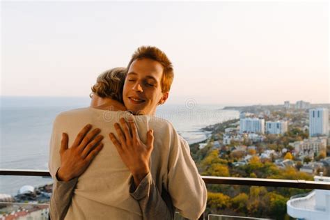 European Gay Couple Smiling And Hugging On Balcony Stock Photo Image Of Home Diversity