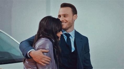 A Man In A Suit And Tie Hugs A Woman S Face As She Stands Next To A Car