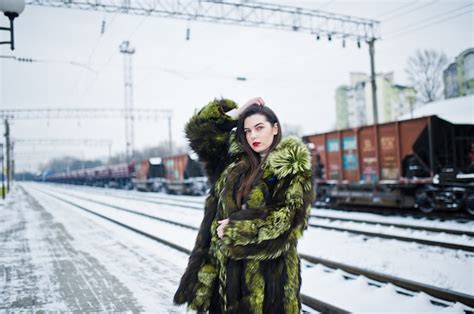 Premium Photo Brunette Girl In Green Fur Coat On The Platform Station At Winter Day