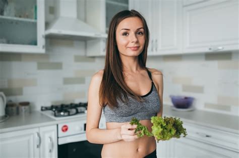 Premium Photo | Fitness girl cooking healthy food