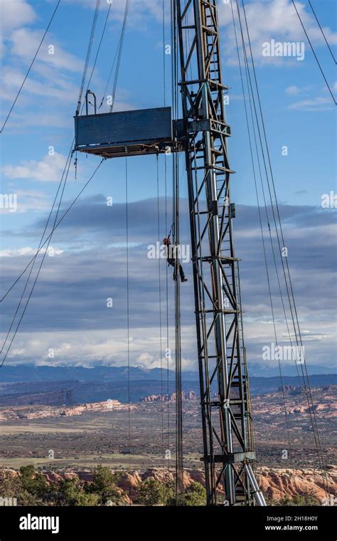 The derrickman being lowered to the ground by his safety harness on an ...