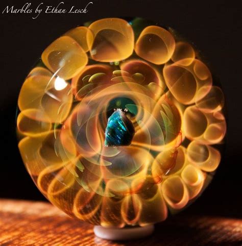 A Glass Ball With An Image Of A Bird Inside It On Top Of A Wooden Table