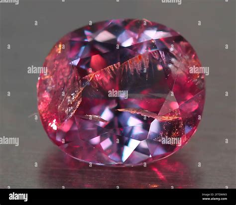 Natural gemstone alexandrite with color change on gray background Stock Photo - Alamy