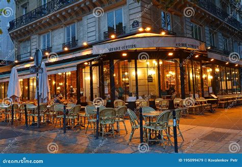 The Traditional French Cafe `deux Palais` At Night It Located Near