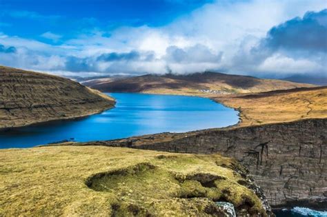 Premium Photo | A view of a lake from the top of a hill.