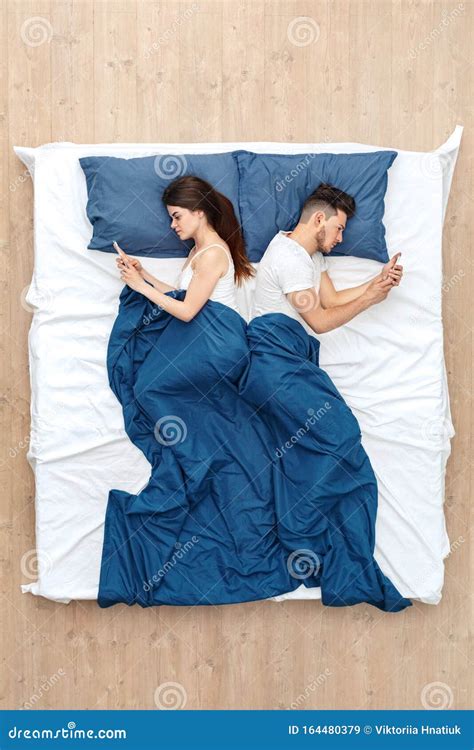 Bedtime Young Couple Lying Under Blanket On Bed Back To Back Top View