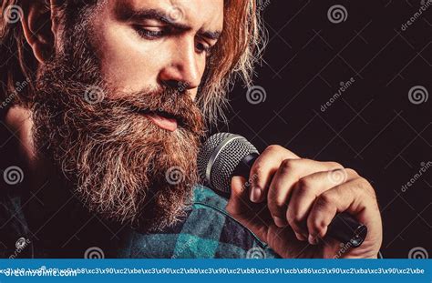 Male Singing With A Microphones Bearded Man In Karaoke Sings A Song Into A Microphone Stock