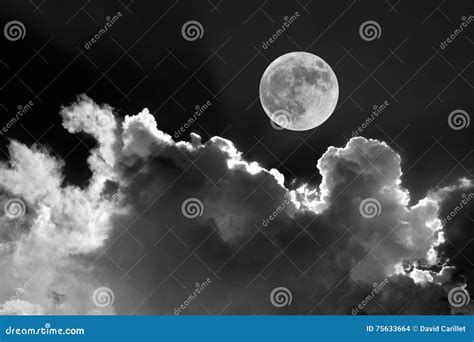 Black And White Of Full Moon In Night Sky With Dreamy Moonlit Clouds