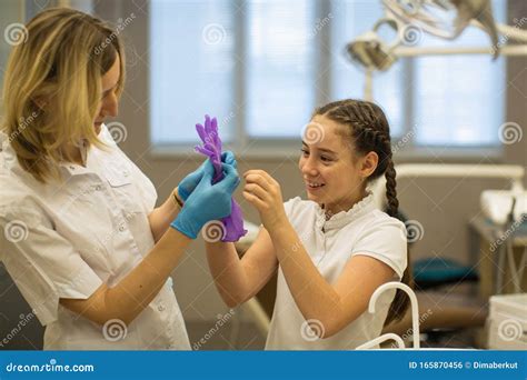 The Dentist With The Help Of A Carpule Syringe Injects Anesthesia Into