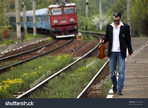 Young Man Waiting For The Train In A Rural Railway Station Stock Photo