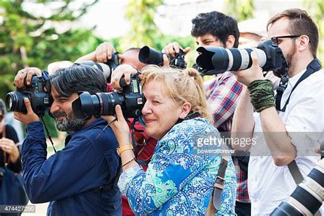 11 Paparazzi Using Flash Photography Along Red Carpet Stock Photos