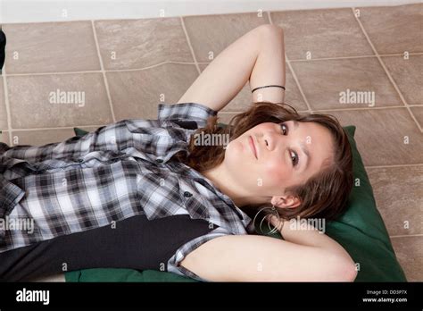 Pretty Brunette Girl Laying Down And Looking At The Camera With A