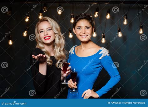 Two Beautiful Girls In Evening Dresses Smiling Holding Wine Glasses Stock Image Image Of