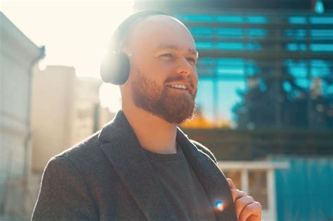 Premium Photo Smiling Bald Bearded Man Enjoys His Headphones While