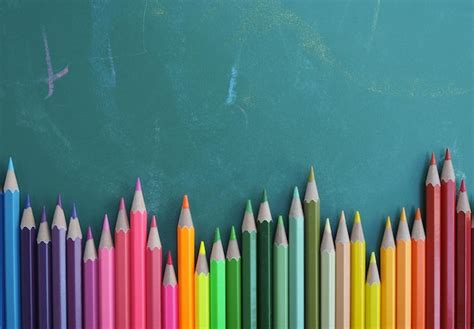 Premium Photo Color Pencils On Chalkboard Background