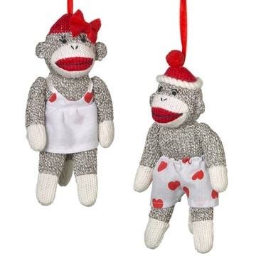 Two Sock Monkey Ornaments Hanging From Strings