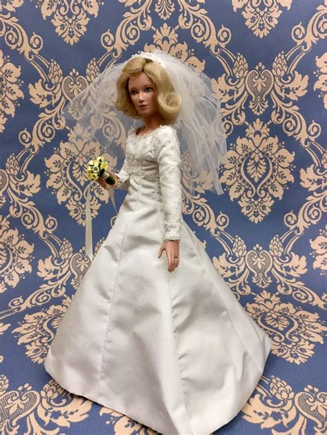 A Barbie Doll Wearing A Wedding Dress And Veil