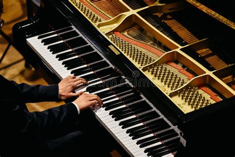 Hands Of Classical Pianist Playing His Piano During A Concert Stock