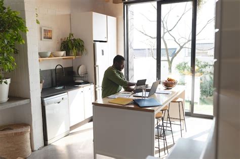 Premium Photo Happy African American Man Sitting At Table In Kitchen