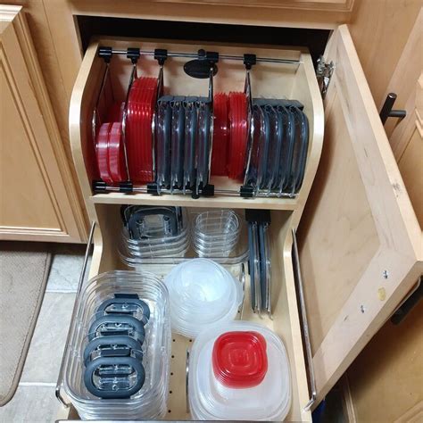 An Organized Kitchen Drawer With Dishes And Utensils In The Bottom