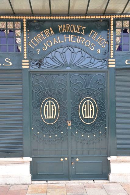 The Front Entrance To An Old Building With Two Doors And Ornate Designs