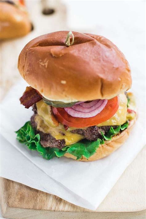 Classic Cheeseburger Recipe On Brioche With Lettuce Tomato And Onions