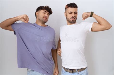 Homosexual Gay Couple Standing Over White Background Stretching Back