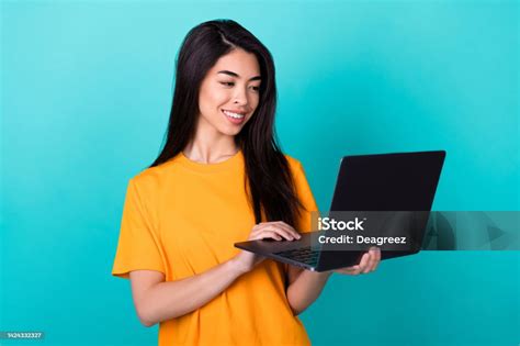 Photo Of Smart Brunette Lady Look Laptop Wear Orange Tshirt Isolated On