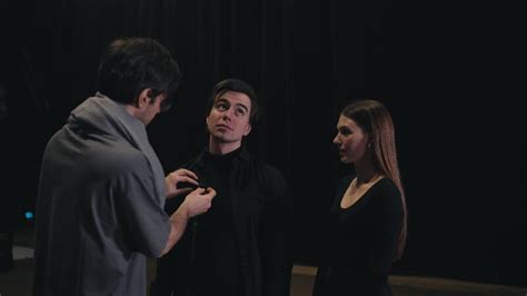 A Confident Brunette Man In A Gray T Shirt And Scarf The Stage Director