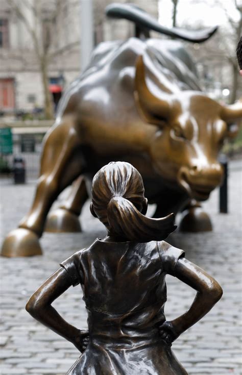 Fearless Girl Statue Stares Down Wall Streets Iconic Bull The