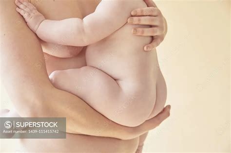 Naked Mother Carrying Naked Baby In Arms Superstock