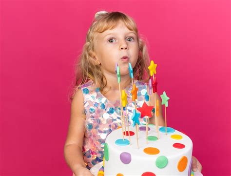 Petite Fille Blonde Excitée Tenant Un Gâteau D anniversaire Isolé Sur Un Mur Rose Avec Espace