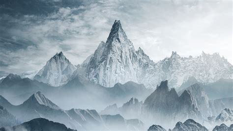 Landscape View Of Mountains With Snow Frozen Mist In White Clouds Sky