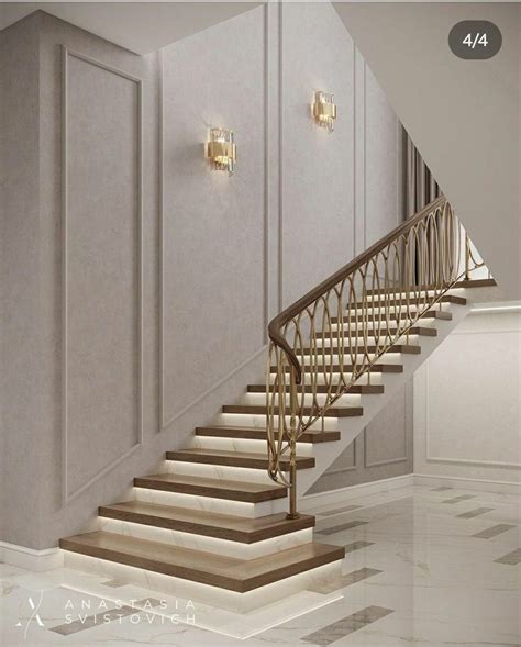 An Elegant Staircase With Golden Handrails In A White Room