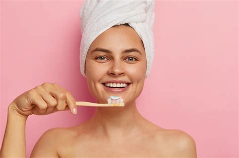 Free Photo Cropped Image Of Happy European Woman Brushes Teeth Holds