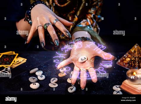 The Fortune Teller Holds A Rune With A Luminous Astrological Circle