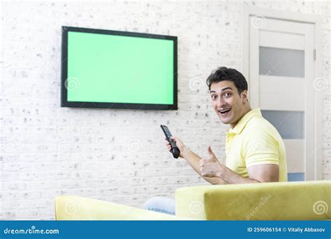 Man Sitting on the Couch, Watching Tv and Showing Thumbs Up Stock Photo - Image of interior ...