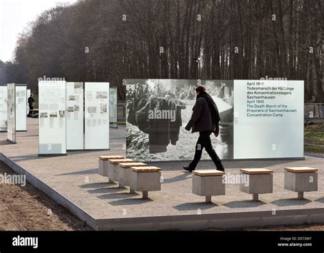 A man passes new information boards of the memorial site for the death ...