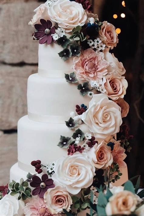 A White Wedding Cake With Flowers On It