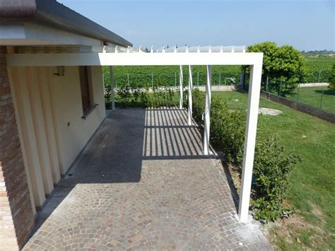 An Outdoor Patio With Pergolated Area And Brick Walkway