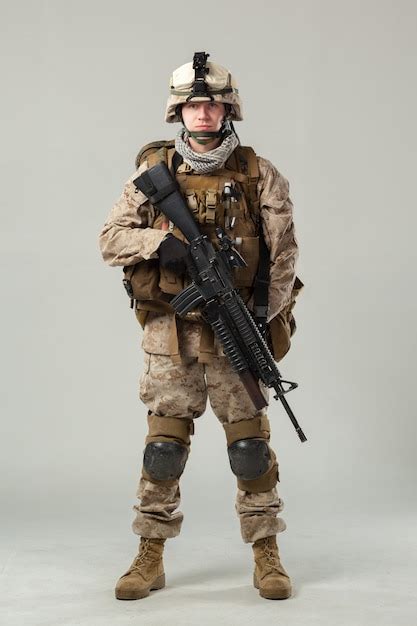 Premium Photo Soldier In Camouflage Holding Rifle