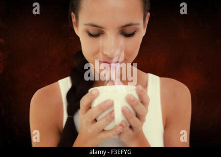 Composite Image Of Pretty Brunette Having Cup Of Tea Stock Photo Alamy