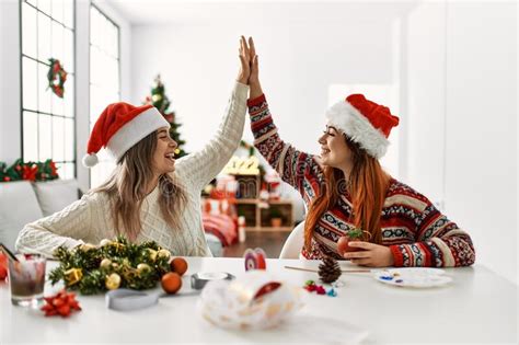 Woman Couple Making Handmade Christmas Decoration High Five Raised Up